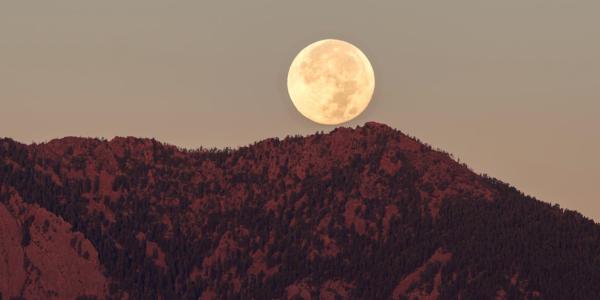 Moon rises over the Boulder Flatirons