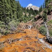 Iron oxides stain the bed of Upper East Mancos River in southwestern babyֱapp